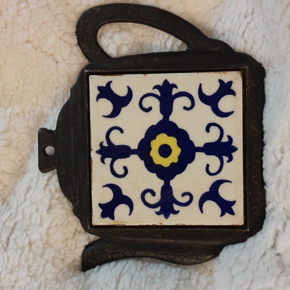 Vintage iron and ceramic trivet